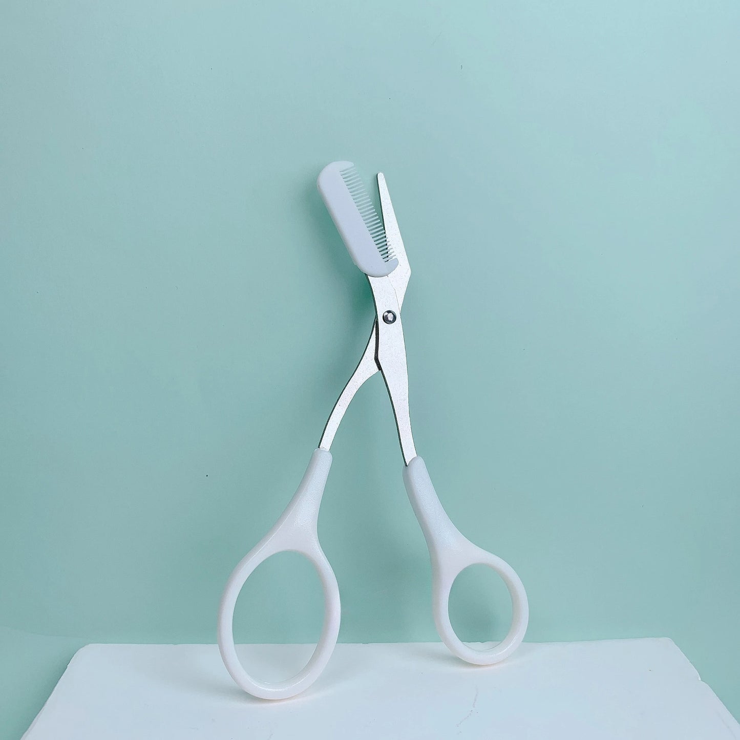 Pink eyebrow trimming scissors with built-in comb - stainless